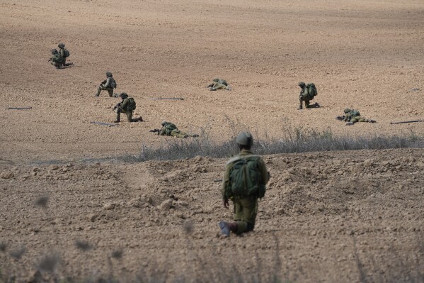 Israeli soldiers take positions near Kibbutz Kfar Azza on Tuesday, Oct. 10, 2023. Hamas militants overran Kfar Azza on Saturday, where many Israelis were killed and taken captive. (AP Photo/Ohad Zwigenberg)